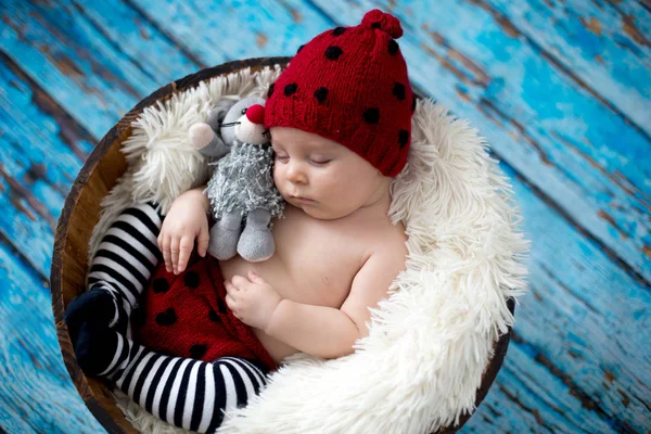 Little baby boy with knitted hat in a basket, happily smiling — Stock Photo, Image