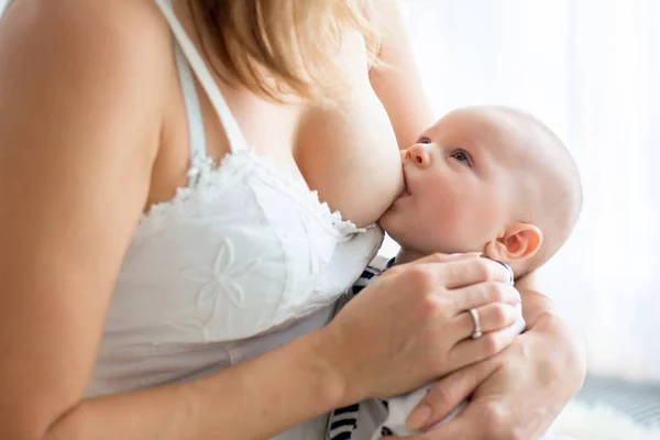 Jovem mãe amamentando seu bebê recém-nascido menino — Fotografia de Stock