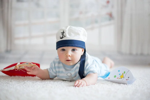 Little baby boy, playing wtih little boat and little fish at hom — Stock Photo, Image