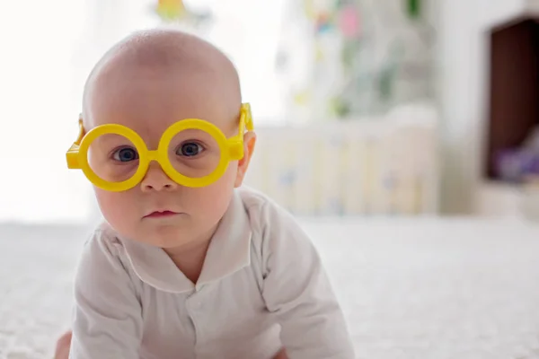 Little baby boy, toddler, playing at home with funny eye glasses — Stock Photo, Image