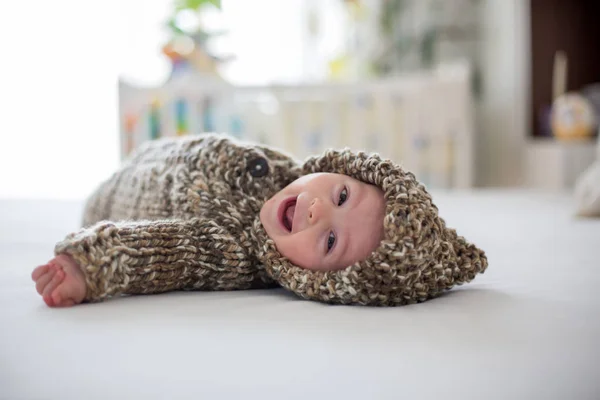 Little baby boy playing at home with soft teddy bear toys, lying — Stock Photo, Image