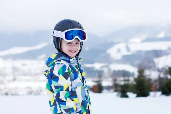 Мила маленька дошкільна дитина в блакитній куртці, катається на лижах щасливо на — стокове фото