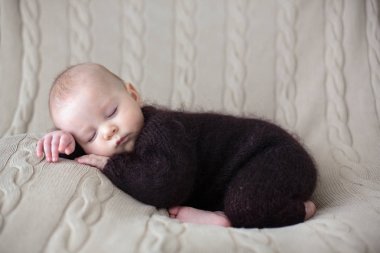 Tatlı küçük bebek çocuk, el yapımı örgü kahverengi yumuşak te içinde giyinmiş