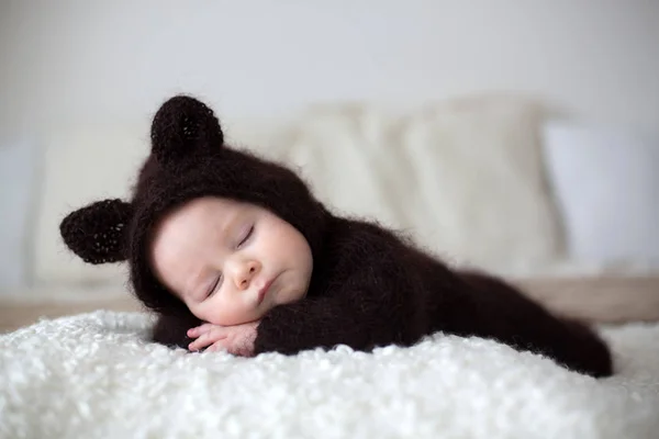 Sweet little baby boy, dressed in handmade knitted brown soft te — Stock Photo, Image