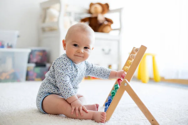 Cute little baby boy, playing with abacus at home — Stock Photo, Image