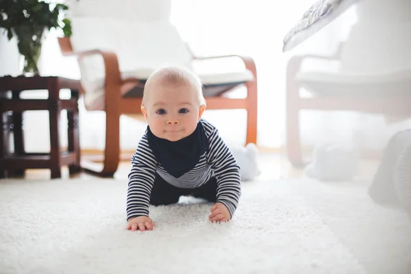 Cute little toddler baby boy, playing at home on the floor in be — Stock Photo, Image