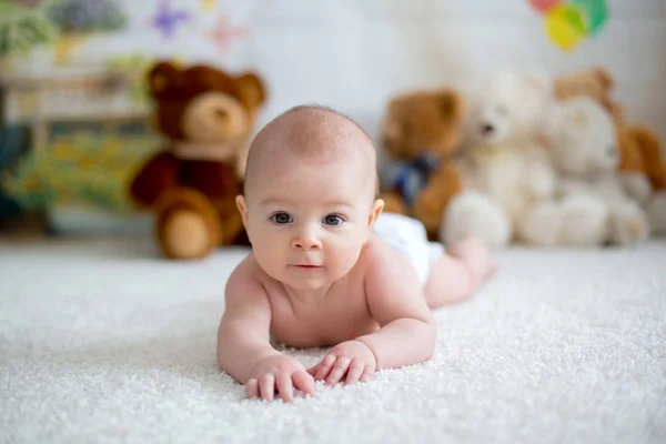 Little baby boy playing at home with soft teddy bear toys — Stock Photo, Image