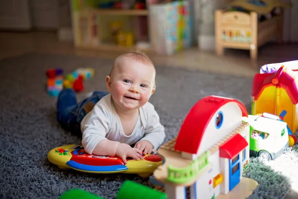 Cute baby toddler boy, playing with lots of colorful constructio — Stock Photo, Image
