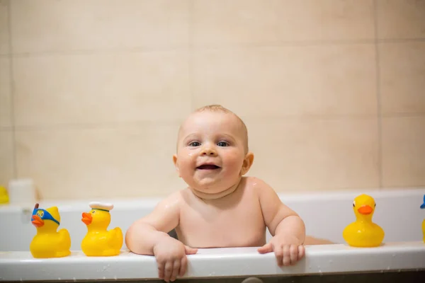 Petit garçon, jouant avec les canards en caoutchouc dans la baignoire — Photo