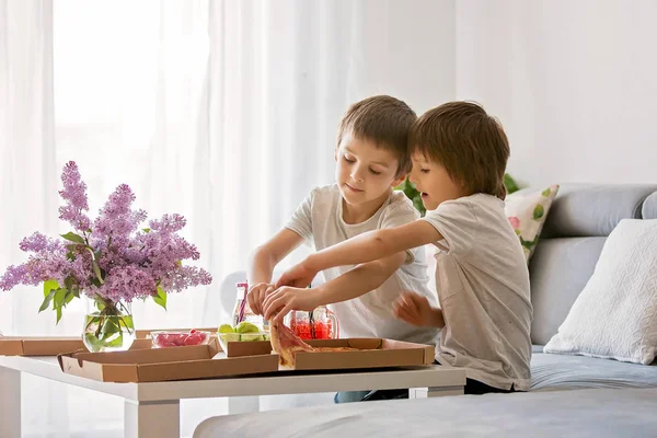 Mooie jonge gezin met kinderen, eten pizza thuis en w — Stockfoto