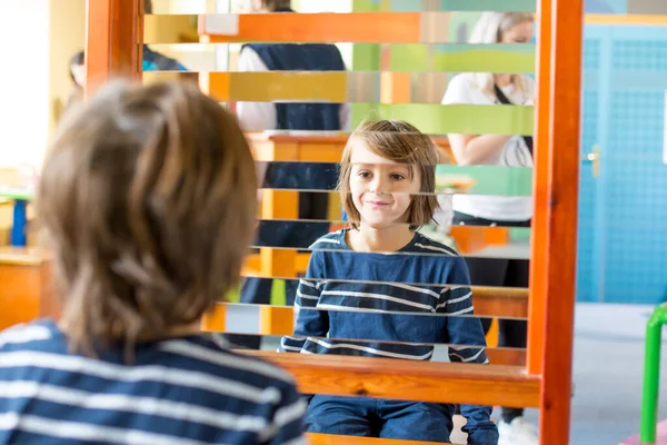 Funny double half portrait of two boys, looking at yourself in a — Stock Photo, Image