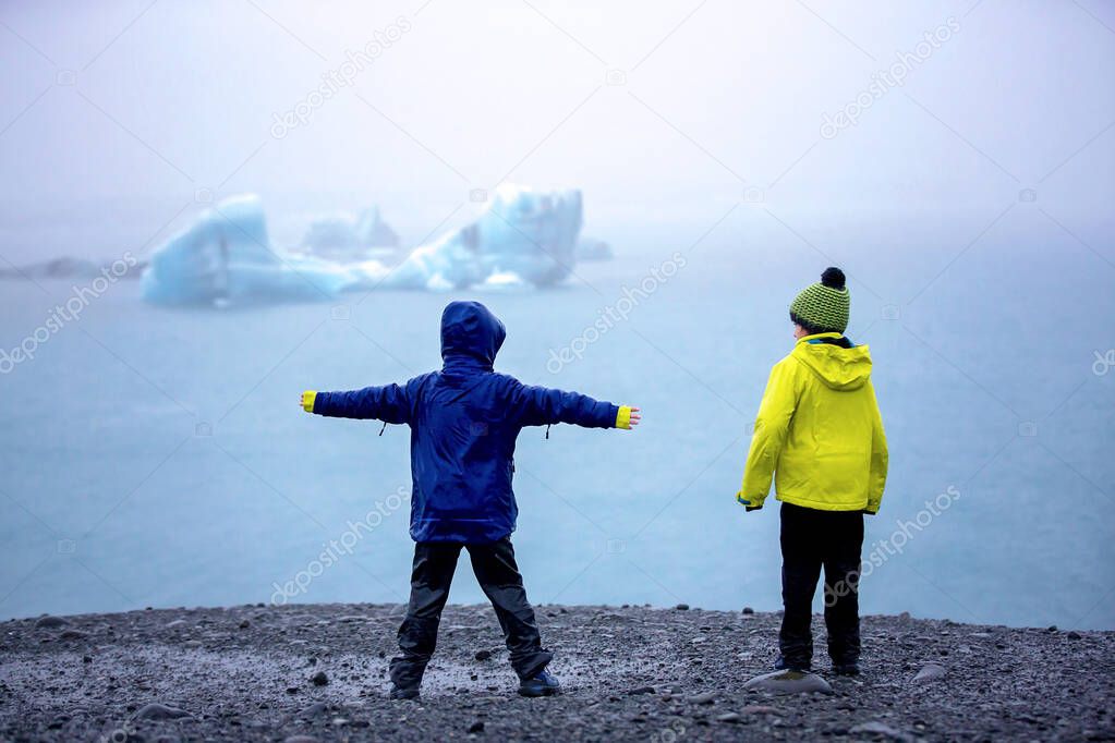 Child, taking picture at early evening on a rainy day at picture