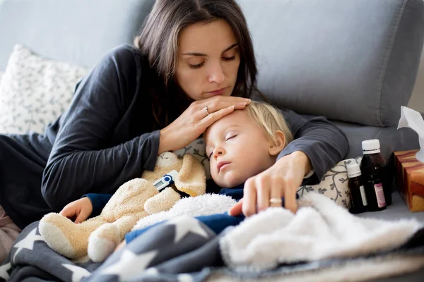 Biondo bambino ragazzo, dormire sul divano in soggiorno, sdraiato d — Foto Stock
