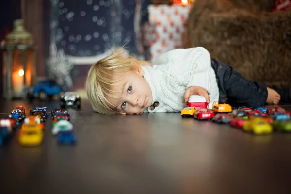 Cute toddler boy, sitting around many car toys on the floor, pla — Stock Photo, Image