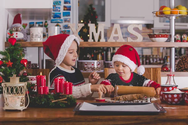 Happy children, boy brothers, baking christmas cookies at home — Stockfoto