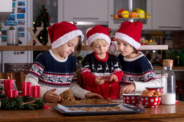 Happy children, boy brothers, baking christmas cookies at home — Stockfoto