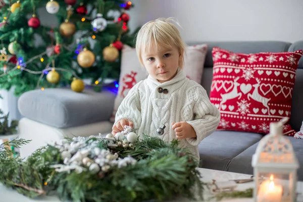 Little cute blonde toddler boy, making advent wreath at home — Stockfoto