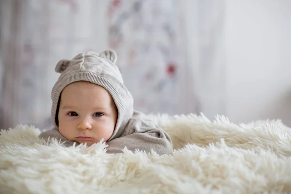 Sweet baby boy in bear overall, sleeping in bed with teddy bear — Stock Photo, Image