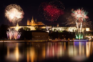 Prag kalesi ve nehir üzerinde güzel renkli havai fişekler.