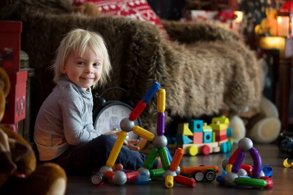 Sweet blonde toddler boy, playing with plastic construction, mak — 图库照片