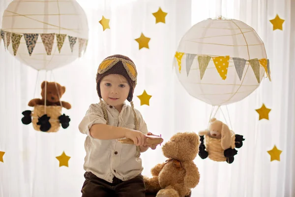 Sweet toddler boy, playing with airplane and teddy bear, air bal — Stok fotoğraf