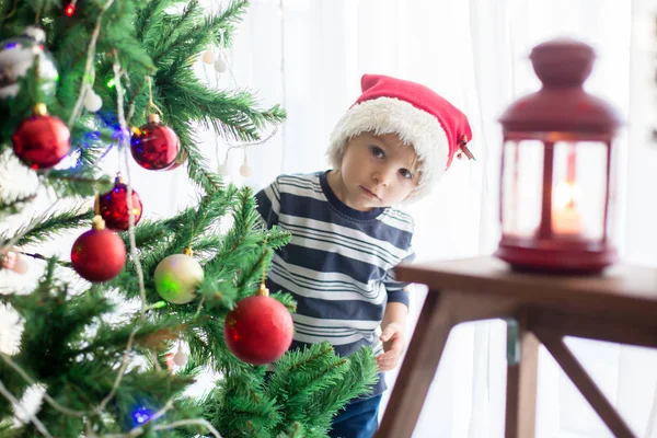 美しいブロンドの幼児の男の子、バルでクリスマスツリーを飾る — ストック写真