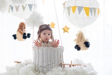 Sweet toddler boy, playing with airplane and teddy bear, air bal