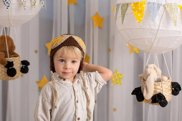 Sweet toddler boy, playing with airplane and teddy bear, air bal — Stockfoto