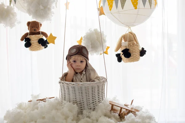 Sweet toddler boy, playing with airplane and teddy bear, air bal — Stockfoto