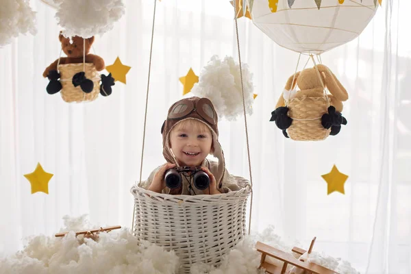 Sweet toddler boy, playing with airplane and teddy bear, air bal — Stok fotoğraf