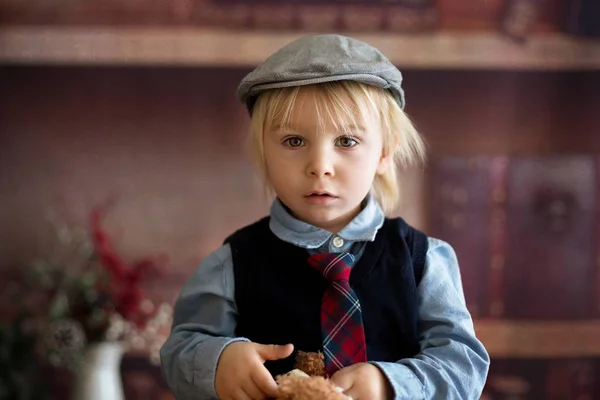 Sweet toddler boy, dressed smart casual, sitting on a wooden cha — Stock Photo, Image