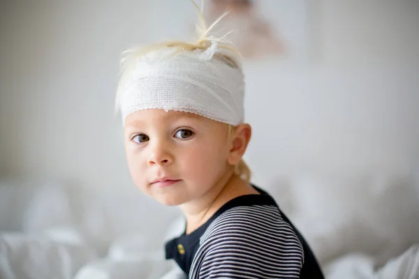 Close portrait of little toddler boy with head injury, sitting i — Stock Image Close portrait of little toddler boy with head injury, sitting i Stock Image