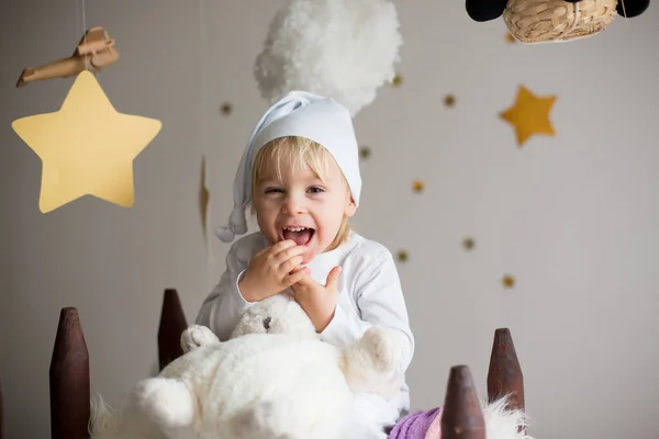 Cute child, blonde boy, playing at night with colorful scarf and — Stock Photo, Image