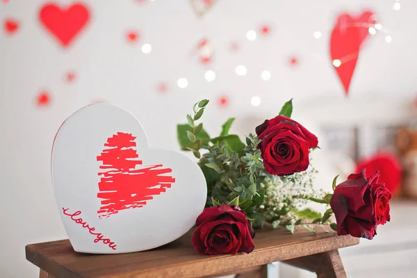 Box in a shape of heart, flowers, red roses and red paper hearts — Stock Photo, Image