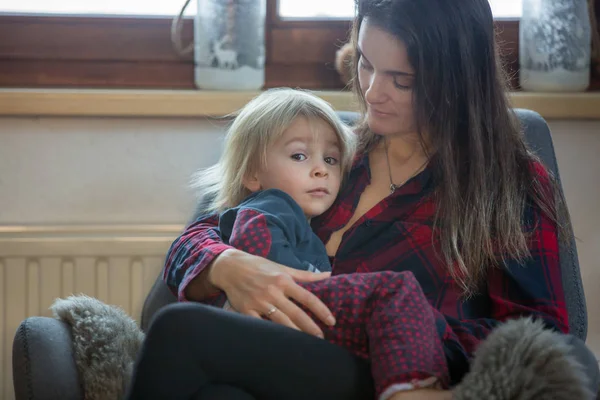 Mother and child, sitting in rocking chair, hugging