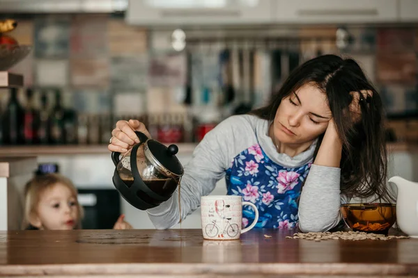 累了的母亲 试图倒咖啡在早晨 女人熬夜后躺在厨房的桌子上 想喝咖啡 — 图库照片