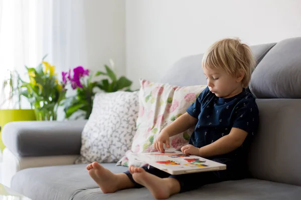 Sweet Blond Toddler Boy Reading Book Home Laughing Family Happiness — Stock Photo, Image