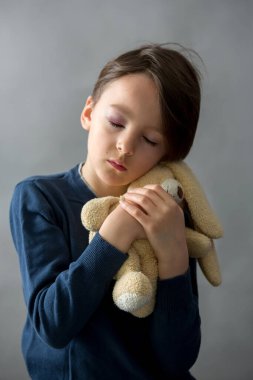 Gözü morarmış, morarmış, çocuk istismarı ve yaralanmış küçük bir okul çocuğu.