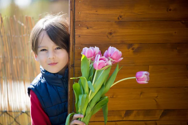 Child Boy Holding Pink Tulips Hiding Them Mothers Day Gift — Stock Photo, Image
