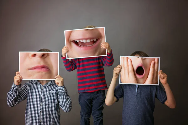 Three Children Boy Brothers Showing Different Emotions Hiding Paper Expression — Stock Photo, Image