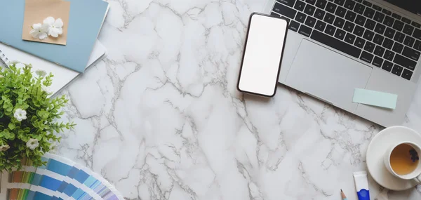 Overhead shot of light blue feminine designer workspace with blank screen smartphone and laptop computer — Stock Photo, Image