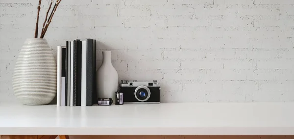 Minimal workplace with office supplies and copy space on white table and white brick wall background — Stock Photo, Image