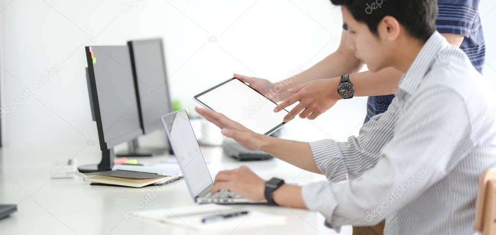 Group of professional UX graphic designer working on smartphone template together in modern office room 