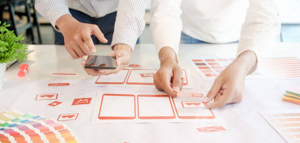 Cropped shot of young professional UX graphic designer team developing the smartphone templates in office room