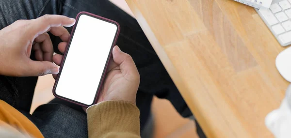 Närbild av ung man som håller blank skärm smartphone i bekväma kontorsrum — Stockfoto