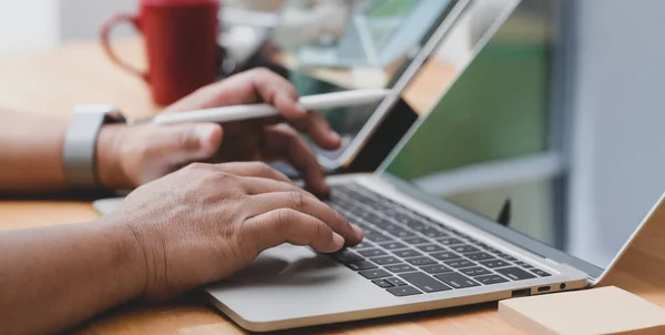 Close up view of businessman typing on laptop while working his project in office room — 스톡 사진