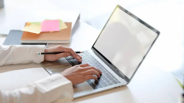 Close up view of  professional businessman typing on blank screen laptop and office supplies — 스톡 사진