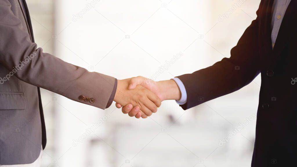 Two of business people shaking hands after finishing up a meeting 