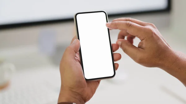 Close up view of male freelancer typing  smartphone while sitting in modern workspace — Stock Photo, Image