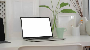 Boş ekran dizüstü bilgisayar, tablet, boya fırçası ve dekorasyonla modaya uygun sanatçı işyerinin kırpılmış görüntüleri 